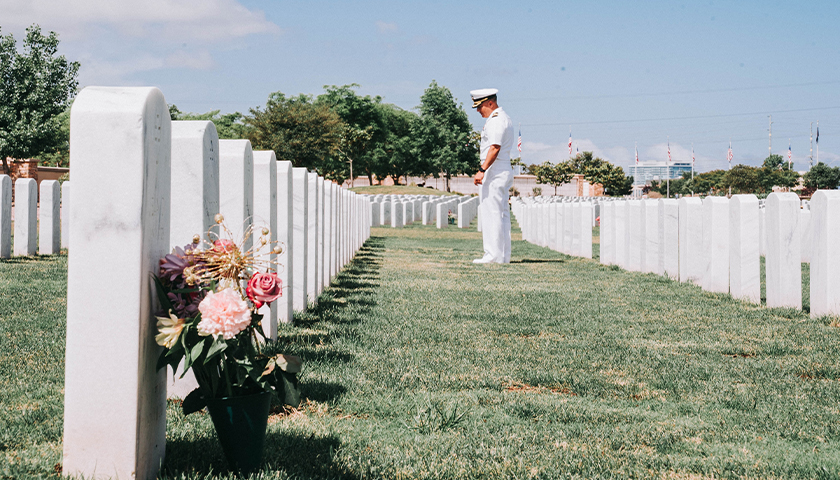 Soldier at gravesite of U.S. veterans