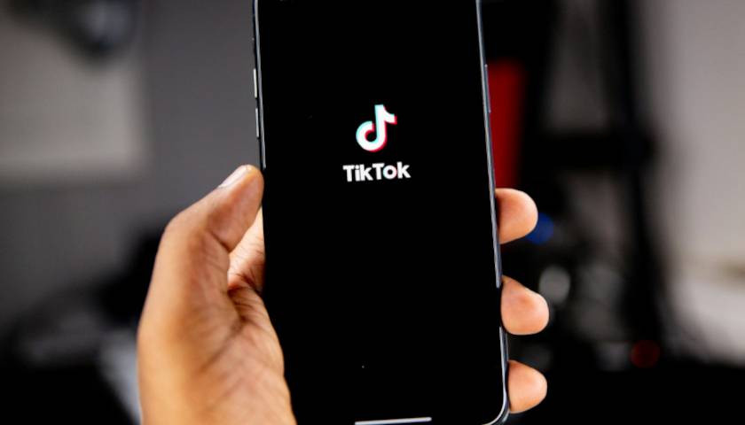 iPhone with TikTok app logo
