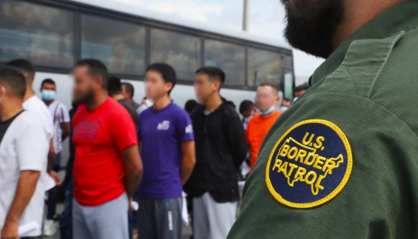 US CBP Agent with migrants